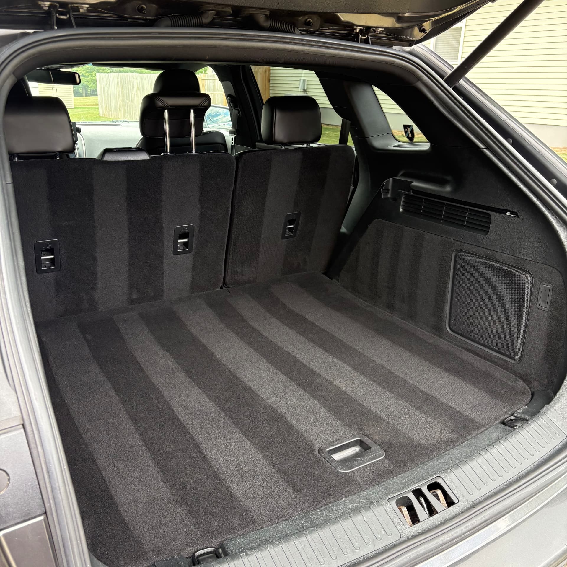 Freshly cleaned black carpet in an SUV cargo area