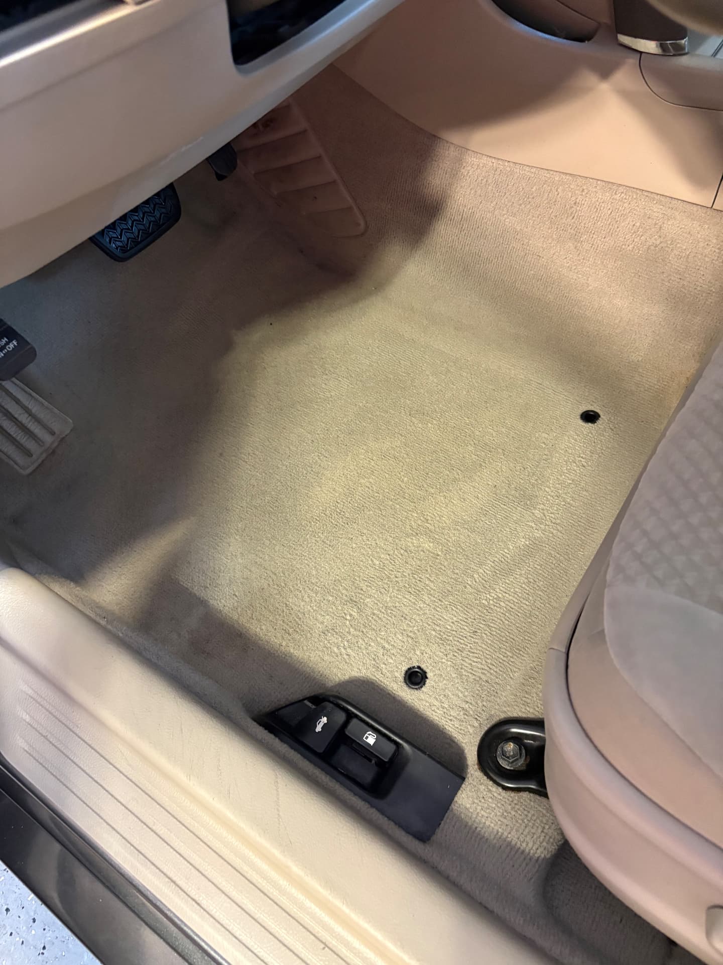 The same driver-side carpet freshly extracted and cleaned after detailing
